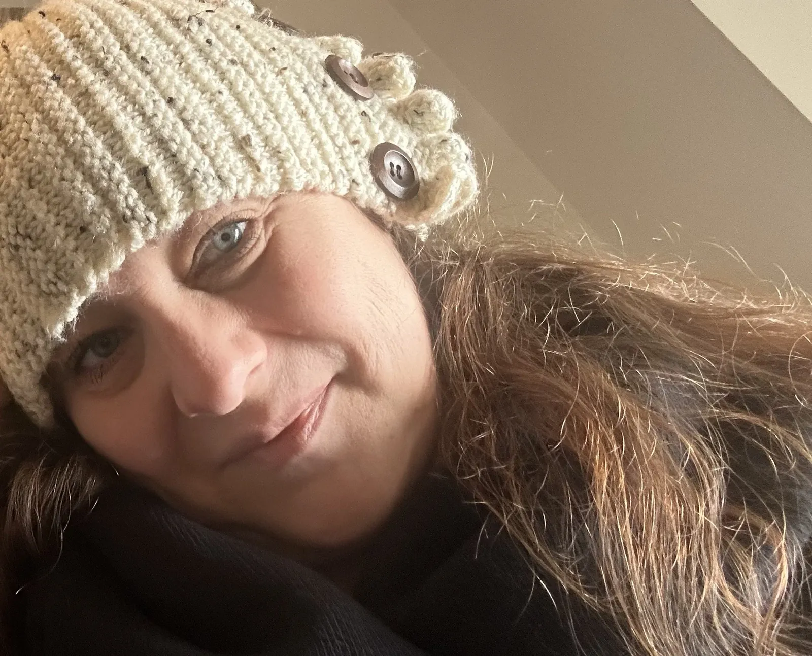 Alysha wearing a cream knit hat
